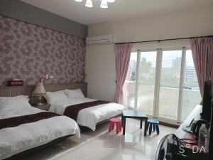 Ein Bett oder Betten in einem Zimmer der Unterkunft Happy Life B&B