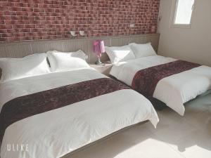 Ein Bett oder Betten in einem Zimmer der Unterkunft Happy Life B&B