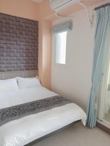 Ein Bett oder Betten in einem Zimmer der Unterkunft Happy Life B&B