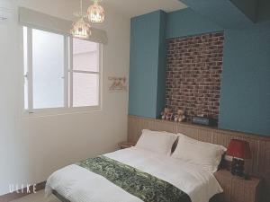 Ein Bett oder Betten in einem Zimmer der Unterkunft Happy Life B&B