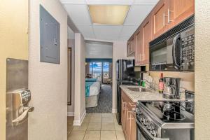 a kitchen with a sink and a stove top oven at Holiday Pavilion 405 in Myrtle Beach