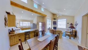 a kitchen and dining room with a wooden table and chairs at Krystal Kiva #K4 in Moab