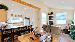 a kitchen and living room with a table and chairs at Jan's Joy #N3 in Moab