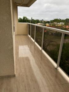 a balcony with a view of a field at Apartamento encantador in Itapoa