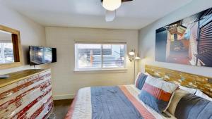 a bedroom with a bed and a flat screen tv at Moab Flats #3 in Moab