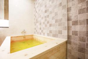 a bath tub with a wooden floor in a bathroom at Paju Golden Hill in Paju