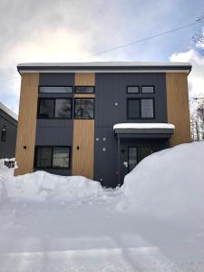 a building with a pile of snow in front of it at Santa's House in Niseko