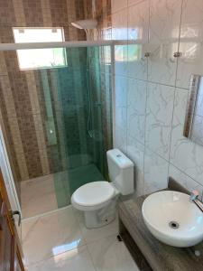 a bathroom with a shower and a toilet and a sink at Ferias floripa 122 in Florianópolis