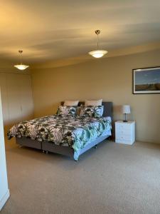 1 dormitorio con 1 cama y 2 luces en Arthur's House at Carrick Winery en Cromwell