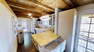 a kitchen with a wooden table and white cabinets at Pack Creek ~ Road House in Moab