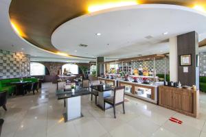 a restaurant with tables and chairs and a bar at The Royale Krakatau in Cilegon