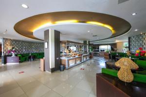 a restaurant with a large lobby with a bar at The Royale Krakatau in Cilegon
