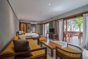 a hotel room with a bed and a living room at Banana Fan Sea Resort in Chaweng