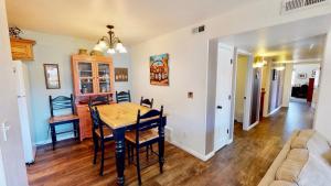 a dining room and living room with a table and chairs at Red Cliff Condos #1H in Moab