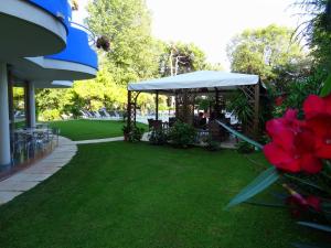 a gazebo with a table and chairs on a lawn at Hotel Playa Blanca in Duna Verde