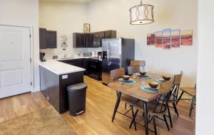 a kitchen and dining room with a table and a refrigerator at Red Cliff Condos #6i in Moab
