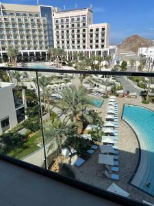 a view of a resort with a pool and buildings at luxury sea view Address Hotel apartment Fujairah in Fujairah