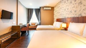 Postel nebo postele na pokoji v ubytování Le'venue Hotel