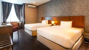 Postel nebo postele na pokoji v ubytování Le'venue Hotel