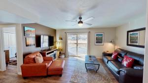a living room with a couch and a ceiling fan at Red Cliff Condos #3E in Moab