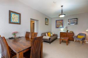 a living room with a dining table and a couch at Maison del Mar in Hobart