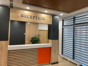 a reception area of a hospital with a sign that reads reception at Olympic Hotel in Türkistan