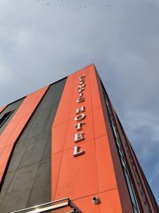 a building with a sign on the side of it at Olympic Hotel in Türkistan