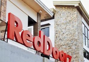 a sign for a restaurant in front of a building at RedDoorz @ Guest Hotel Passi City Iloilo in Balatocon