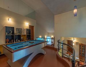 a large room with a pool table in it at SaffronStays Aurelia, Panchgani - Balinese villa with breathtaking valley views in Panchgani