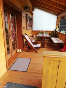 a porch of a cabin with a table and benches at Chata Kaprík in Liptovský Mikuláš