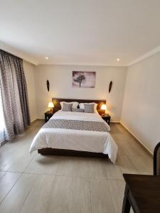 A bed or beds in a room at Tala Cottages