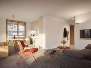 a living room with a couch and a table at Ferienwohnung 3,5 Zimmer direkt an Ski- und Bikepiste in Flims