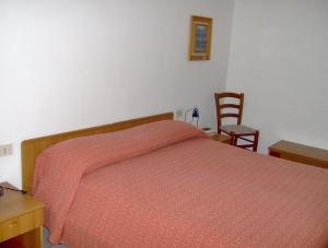 Postel nebo postele na pokoji v ubytování Hotel Svizzero