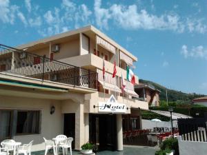 a hotel with tables and chairs in front of it at Hotel Svizzero in Sangineto +60 photos