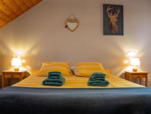 a bedroom with a bed with blue towels on it at Les Garianes in Saint-Léger-les-Mélèzes +21 photos