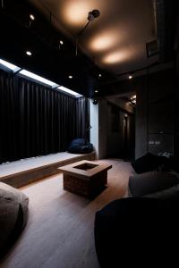 a living room with a couch and a coffee table at 生活就是Lifeis民宿新城館-寵物KTV包棟 in Kangle