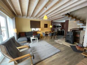 a living room with a couch and a table at Szarejkowe Wzgórza in Szarejki