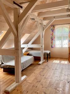a bedroom with two bunk beds in a attic at Czarna Jachta - Na szlaku legend - - - - - Pokoje nad jeziorem in Kruklanki