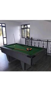 a pool table in a living room with at Sunrise Sensation holiday home. in Centre de Flacq