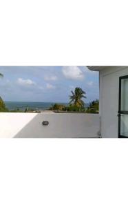 a white house with a view of the ocean at Sunrise Sensation holiday home. in Centre de Flacq