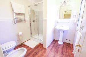 a bathroom with a shower and a toilet and a sink at 96 Guest House in Reggio di Calabria