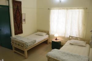 Ліжко або ліжка в номері Bhitey Homestay SIMANTAPALLY / SHANTINIKETAN