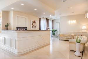 a large living room with a reception counter at Hotel & Residence Exclusive in Marina di Carrara