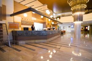 a woman standing behind a counter in a lobby at Golden Port Salou & Spa in Salou