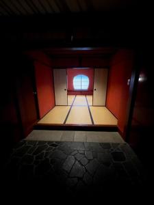a dark room with a door and a window at Kyotoya in Takeo