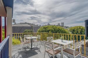 a patio with tables and chairs on a balcony at The Wharf Inn in San Francisco