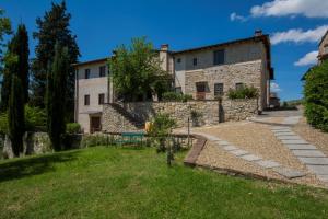 an external view of a stone house with a garden at Borgo Bottaia in Grassina