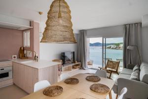 a kitchen and living room with a view of the ocean at JUST EXPERIENCE MALLORCA in Andratx