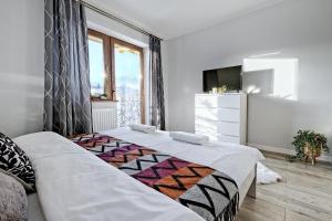 Posteľ alebo postele v izbe v ubytovaní Apartamenty Maciejka Odkryj Zakopane + 37 fotografií