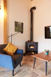 a living room with a couch and a wood stove at Sustainable Rural House La Lisa Dorada in Agulo